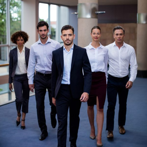 Portrait of business executives walking in a conference center lobby