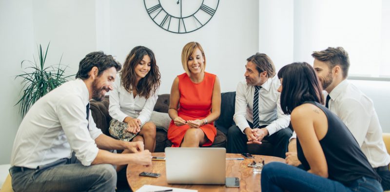 cheerful-workers-watching-the-laptop